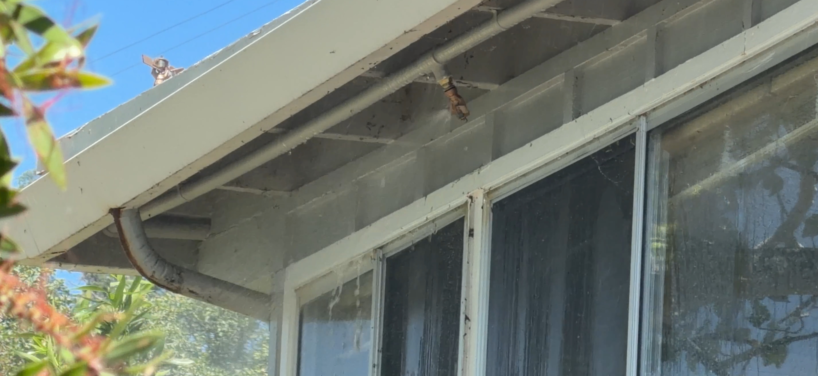 Precision nozzle mounted under eave